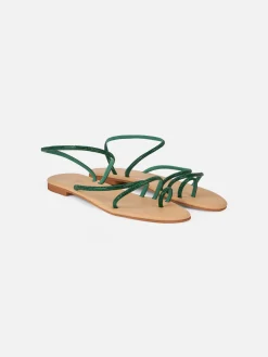 Flache Ringsandalen mit grünen Strasssteinen